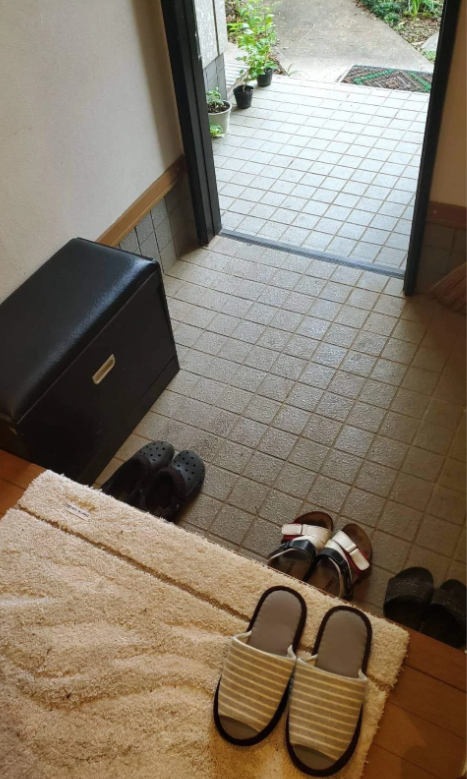 Taking off shoes at the entrance of traditional Japanese houses